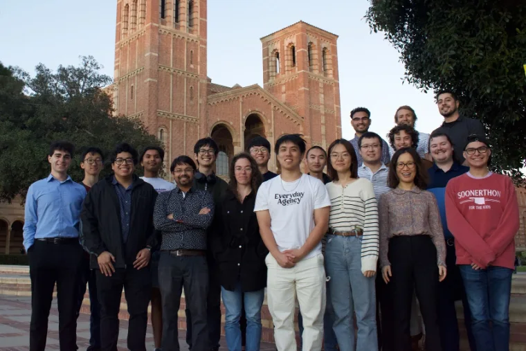 The Kwon Lab, about twenty people, in front of Royce Hall's brick towers at UCLA. Bassel stands at the far left in a light blue shirt.