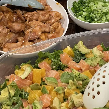Teriyaki chicken and a salmon and avocado salad, with broccoli, scallions and rice