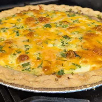 A golden quiche in its pie dish