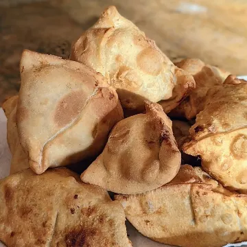 A pile of golden vegetable samosas